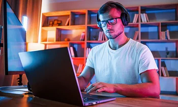 Student working with headphones and glasses
