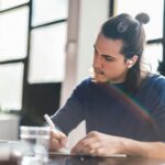 Student using AI tools while studying and taking notes