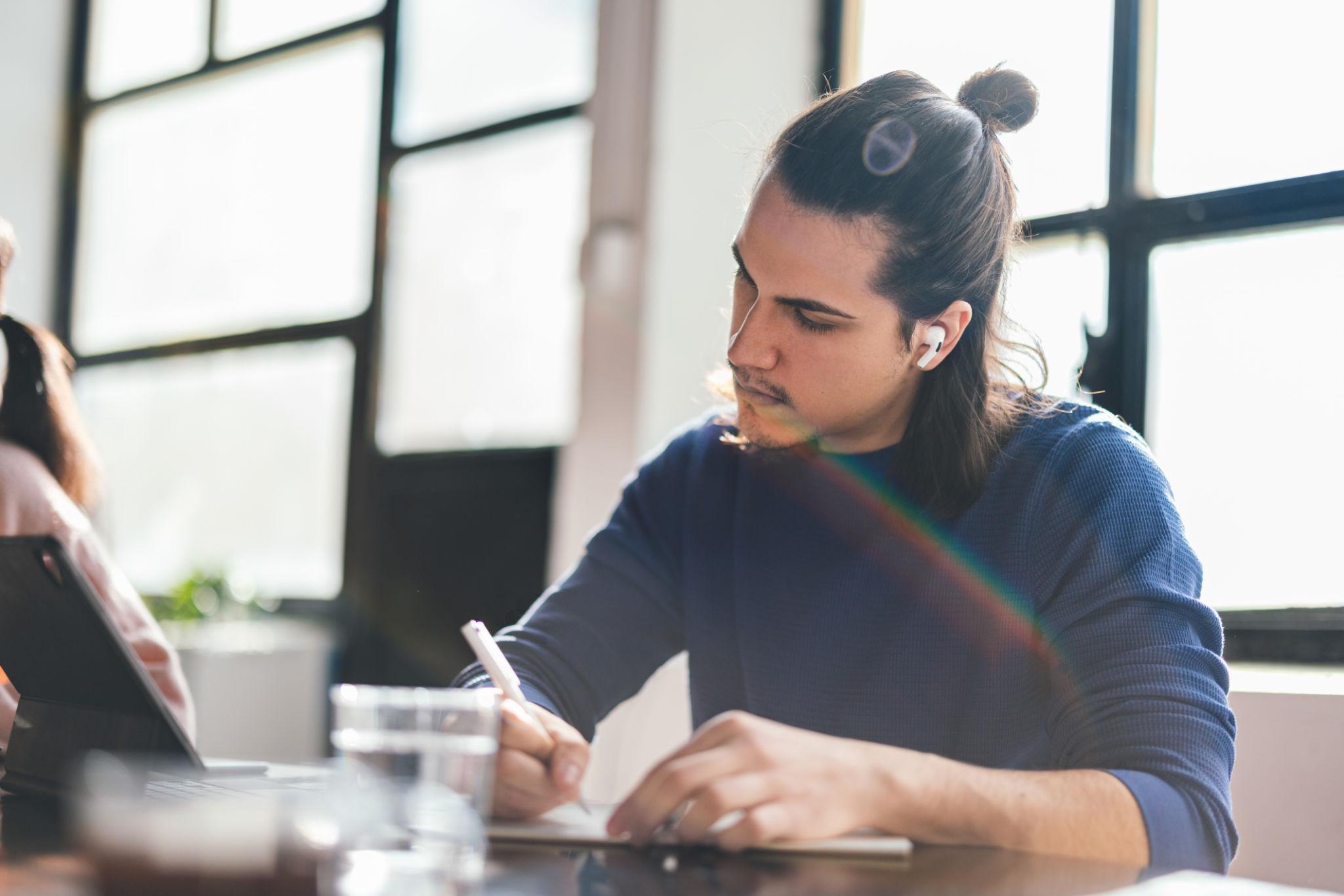 Student using AI tools while studying and taking notes